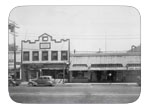 East of North Street between B and A street., circa 1946. View of garage, G.E. Schulze building, built in 1892 following a fire to John Casey's Blacksmith shop. After Schulze's death in 1963, it was used for offices and a hotel. The Dixon Theatre was built in 1926 by Gerlach